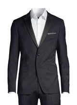 A navy double-breasted suit jacket displayed on a headless mannequin torso, styled with a crisp white dress shirt and a blue patterned pocket square, set against a plain white background.